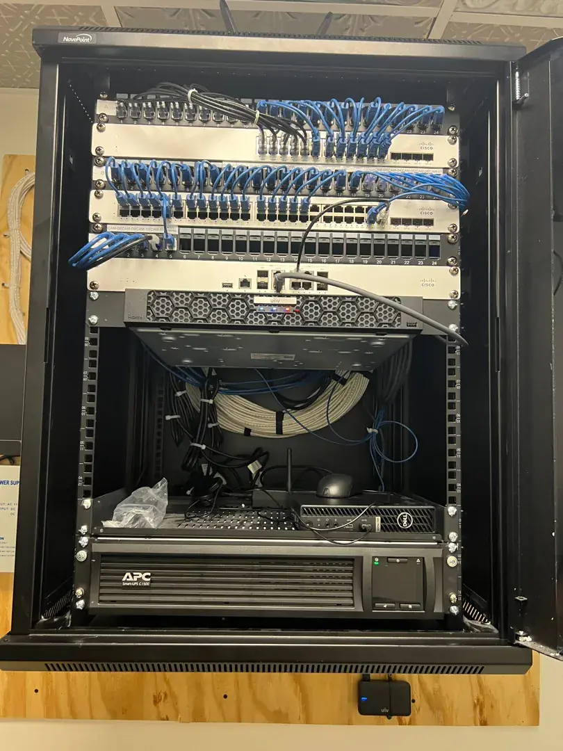 15U network cabinet with Leviton patch panels, NVR, and APC battery backup at the Palmetto project