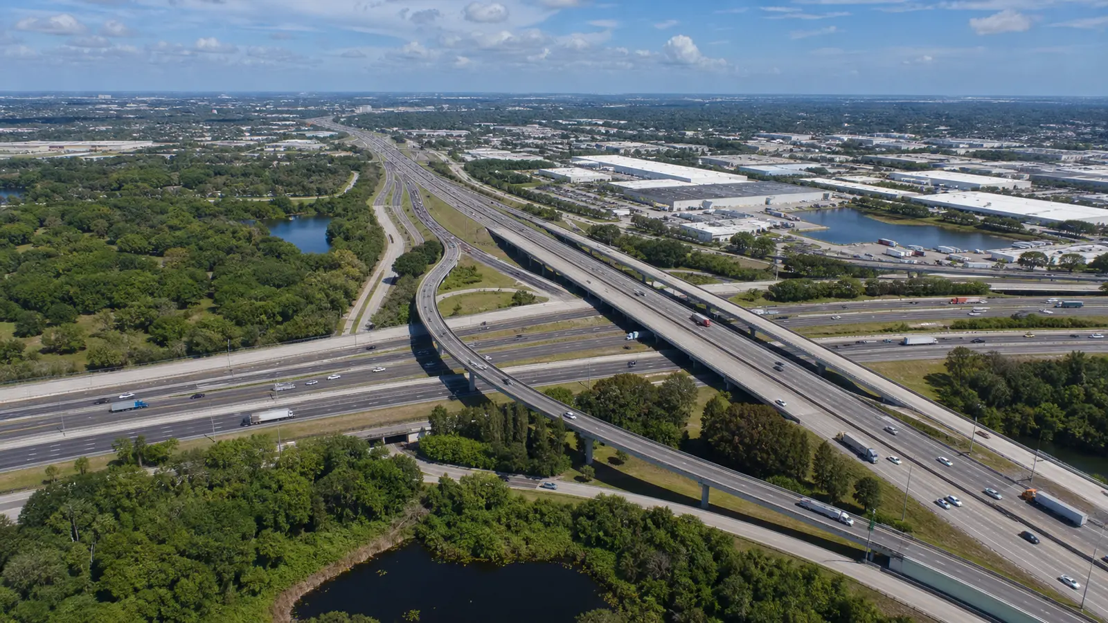 Aerial view of a major Tampa-area interstate and logistics corridor with warehouses and truck traffic
