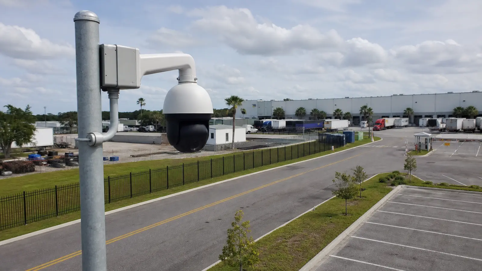 Professional PTZ security camera mounted on a proper pole overlooking a Tampa logistics yard